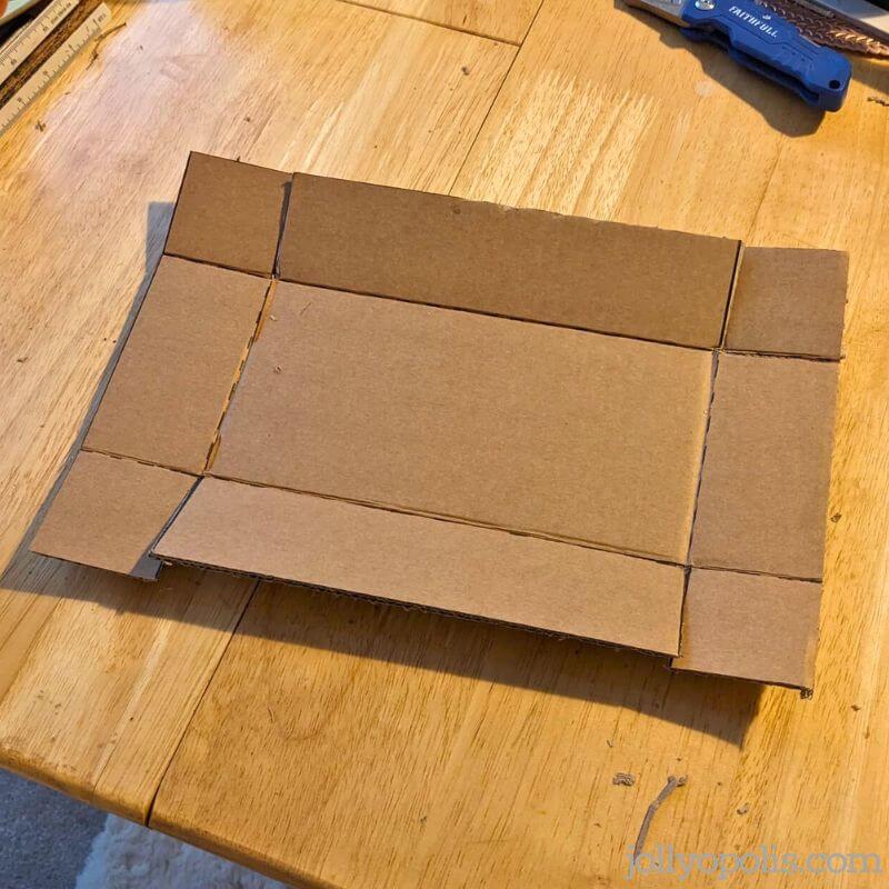 Folding the sides and flaps of the cardboard box into place