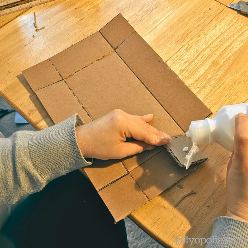 Applying glue to the flaps of the cardboard box